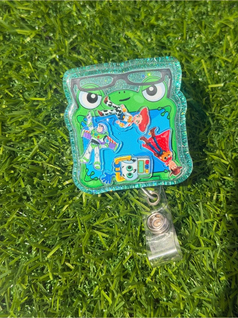 Green Frog Badge Reel with Colorful Toy Story Decals